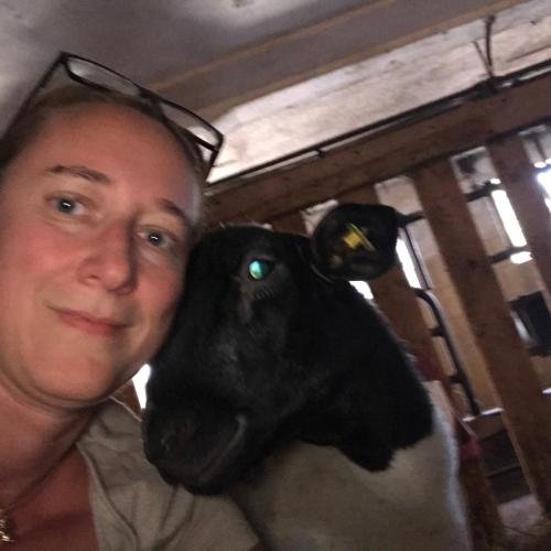 a woman is holding a black and white goat at Wagnermoosgut in Bad Ischl