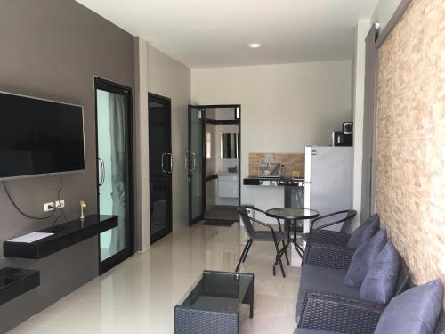 a living room with a couch and a table at Baan Fran Sim Da in Bang Tao Beach