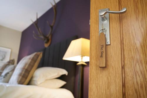 a hotel room with a door with a key on it at The Three Chimneys Country Pub in Biddenden