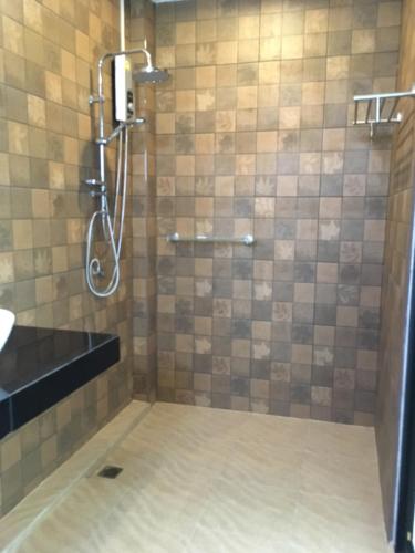 a bathroom with a shower with a sink at Baan Fran Sim Da in Bang Tao Beach