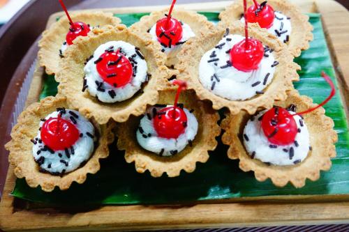 a group of cupcakes with whipped cream and cherries on top at Grand Hatika Hotel in Tanjungpandan