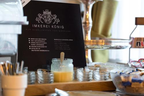 a table with a menu and a stack of coins at Hotel Europa in Münster