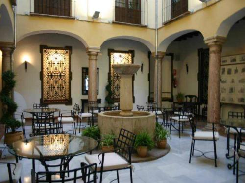 a restaurant with tables and chairs and a fountain at Coso Viejo in Antequera