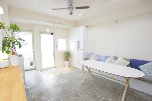 a living room with a couch and a table at Casa Blanca Guesthouse in Nagasaki