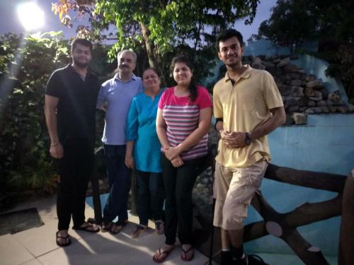 a group of people standing next to a fence at Oxygen Homestay-A Blissful Retreat in Dehradun