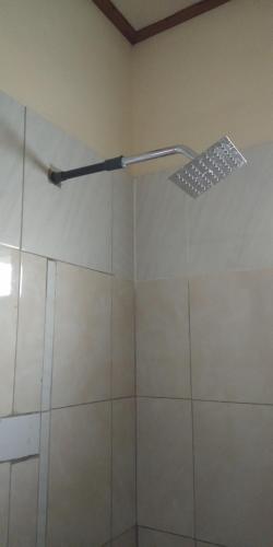 a shower with a glass door in a bathroom at Volcano Living in Kintamani