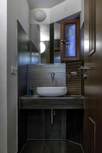 a bathroom with a sink and a mirror at Onefam Míru in Prague