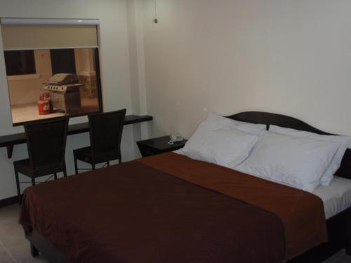 Postel nebo postele na pokoji v ubytování Boomerang Hotel
