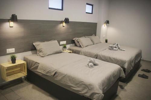 two beds in a room with stuffed animals on them at Vertilex Hotel in Johor Bahru