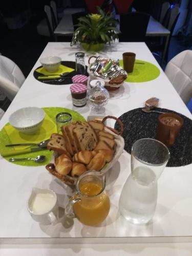 a table with a plate of bread and other foods at La cité des abeilles in Villemandeur