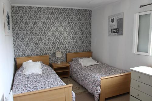 a bedroom with two beds and a dresser at Cute Gite family Aucey Mont Saint Michel in Aucey-la-Plaine