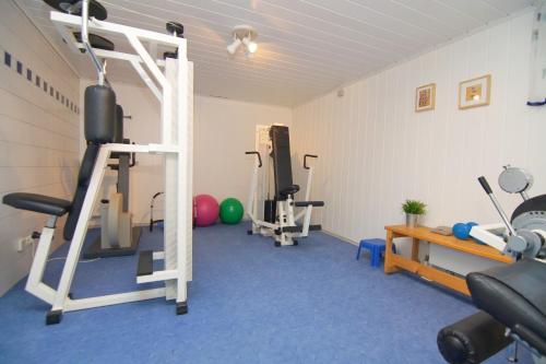a room with a gym with several tread machines at Landhotel Schöll in Parsberg