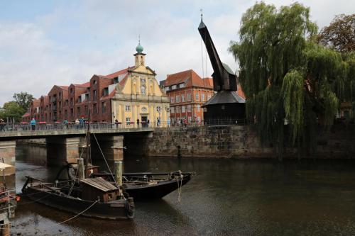a bridge over a river with two boats in the water at Ferienwohnungen / Ferienhaus Wahlers in Bispingen