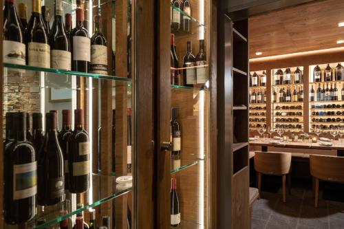 a wine cellar with a display of wine bottles at Hotel Donatz in Samedan