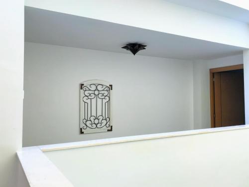 a mirror on the wall of a white room at Triana Luxury Home in Seville