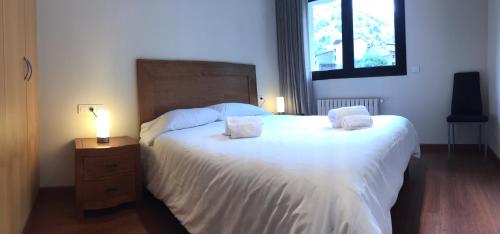 a bedroom with a large bed with two pillows on it at P&C Areny in Canillo