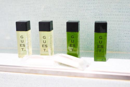 a group of four bottles of green and black mascara at Toledo 16 Luxury Suites in Naples