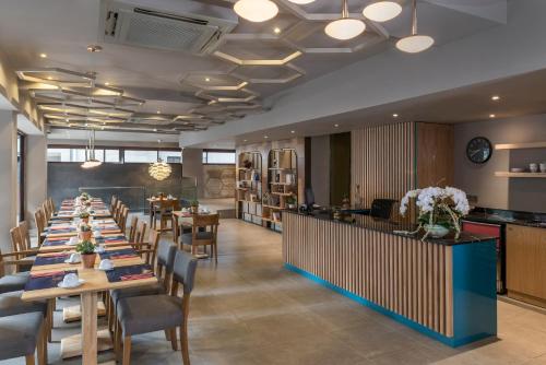 a long dining room with tables and chairs at Upsuites Hotel in Istanbul