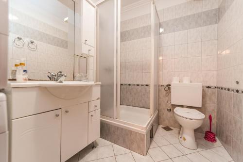 a bathroom with a toilet and a sink and a shower at Apartment Keti in Novalja