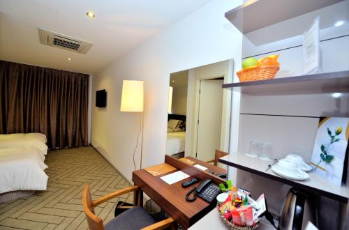 a hotel room with a desk and a bed at Upsuites Hotel in Istanbul