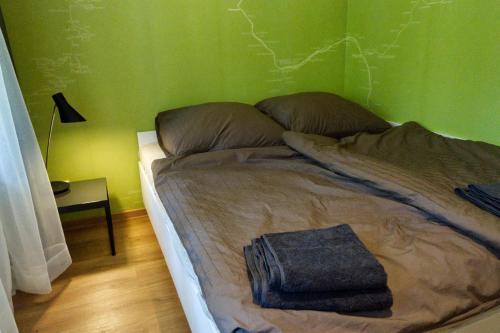 a bed in a room with a green wall at Momerooms – Appartement am Momering in Oberwesel