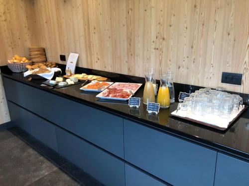a buffet line with different types of food and drinks at Hotel Mareo Dolomites in San Vigilio Di Marebbe