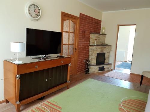 a living room with a flat screen tv and a fireplace at Peipsi Lake House in Kallaste