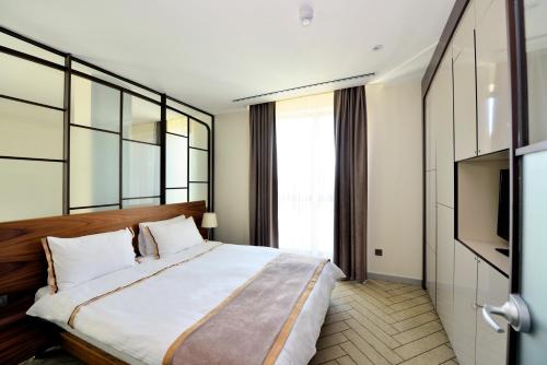 a bedroom with a large bed and a television at Upsuites Hotel in Istanbul