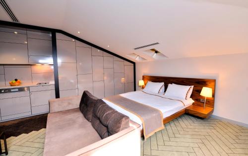 a bedroom with a large bed and a couch at Upsuites Hotel in Istanbul