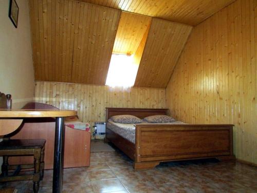 a bedroom with a bed in a wooden room at Hotel Vatra in Lviv