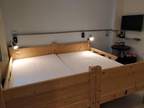 a wooden bed in a room with lights on it at Backpack Home 497 in Jinhu