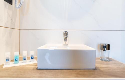 a white bathroom sink sitting on top of a counter at Oasis in Sarti