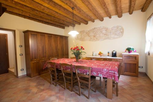 uma cozinha com uma mesa com uma toalha de mesa vermelha em Bed and Breakfast La Quiete em Arcugnano