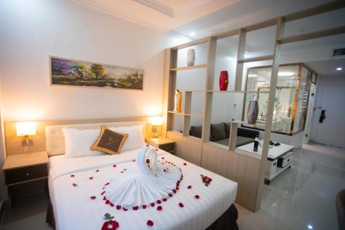 a bedroom with a bed with red flowers on it at Canh Hung Palace in Hai Phong