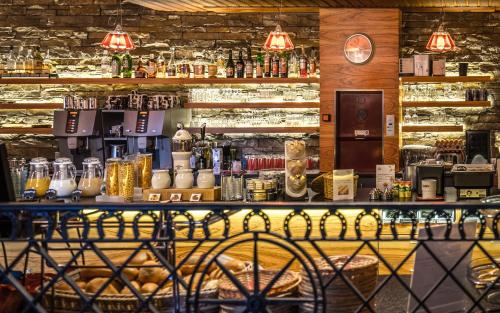 a bar with a counter with a lot of alcohol at Hotel Ochsen 2 by Mountain Hotels in Davos