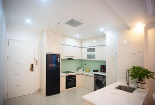 a kitchen with a black refrigerator and a dishwasher at Canh Hung Palace in Hai Phong