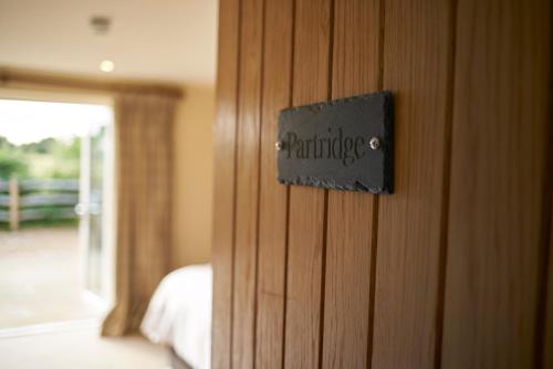 a sign on a wooden door in a bedroom at The Three Chimneys Country Pub in Biddenden