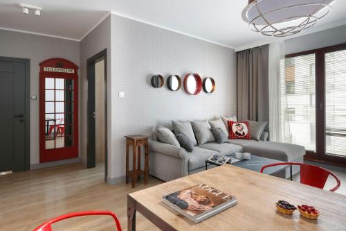 a living room filled with furniture and a window at City Center Apartments SPA & Wellness in Gdańsk