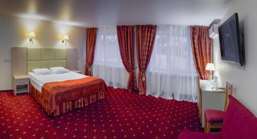 Tempat tidur dalam kamar di AMAKS Russia Hotel