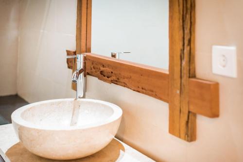 a bathroom with a white sink on a counter at Sitala Villa in Ubud