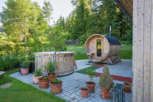 a garden with a sauna and some potted plants at Hotel SLUNEČNÁ LOUKA in Lipno nad Vltavou