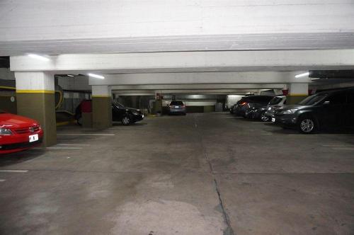 a parking garage with cars parked in it at SUITE 76 en Apart Lima 265 in Buenos Aires