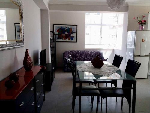 a living room with a glass table and a couch at Apartamento da Praia da Amorosa in Amorosa