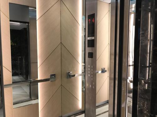 a metal door in a building with a window at Everyday Sukhumvit 11-13 Asok Nana Nightlife in Bangkok