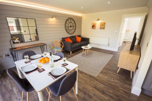 a living room with a table and a couch at The Lakes Rookley in Rookley