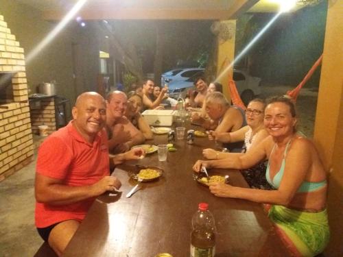 a group of people sitting at a table eating at Vila Alegria in Bombinhas