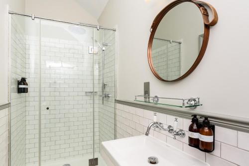 a bathroom with a sink and a mirror at The George Inn in Maulden