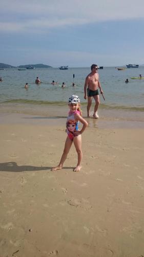 a young child standing on the beach at Vila Alegria in Bombinhas