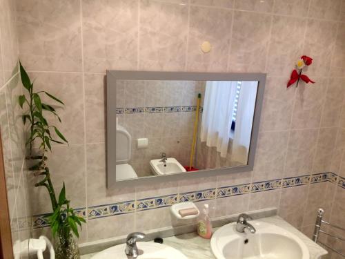 a bathroom with two sinks and a mirror at Templar Secrets House in Tomar