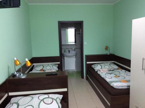 a room with two beds and a sink in it at Ubytování Lábadi in Rohatec